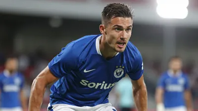 A photorealistic image of a Sirius player, wearing a blue jersey with white shorts, looking focused and determined, with...
