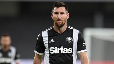 A mid-30s anonymous male football player in a tight waist-up portrait, wearing Sirius' black and white kit, focused...